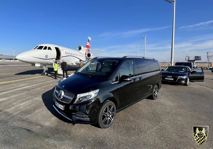 An overview of Oberpfaffenhofen Airport with a luxurious vehicle in the foreground.