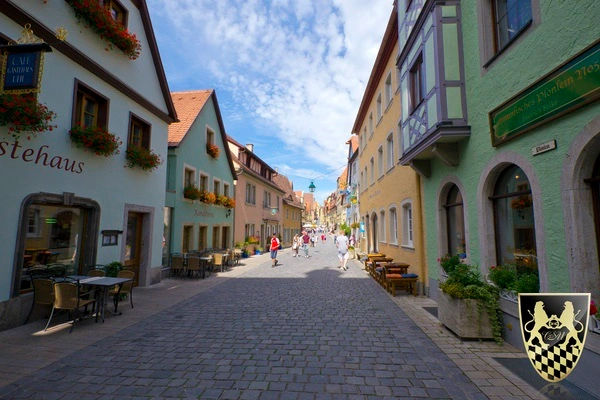 A bustling Christmas market in Rothenburg, filled with festive decorations and visitors enjoying the holiday spirit.